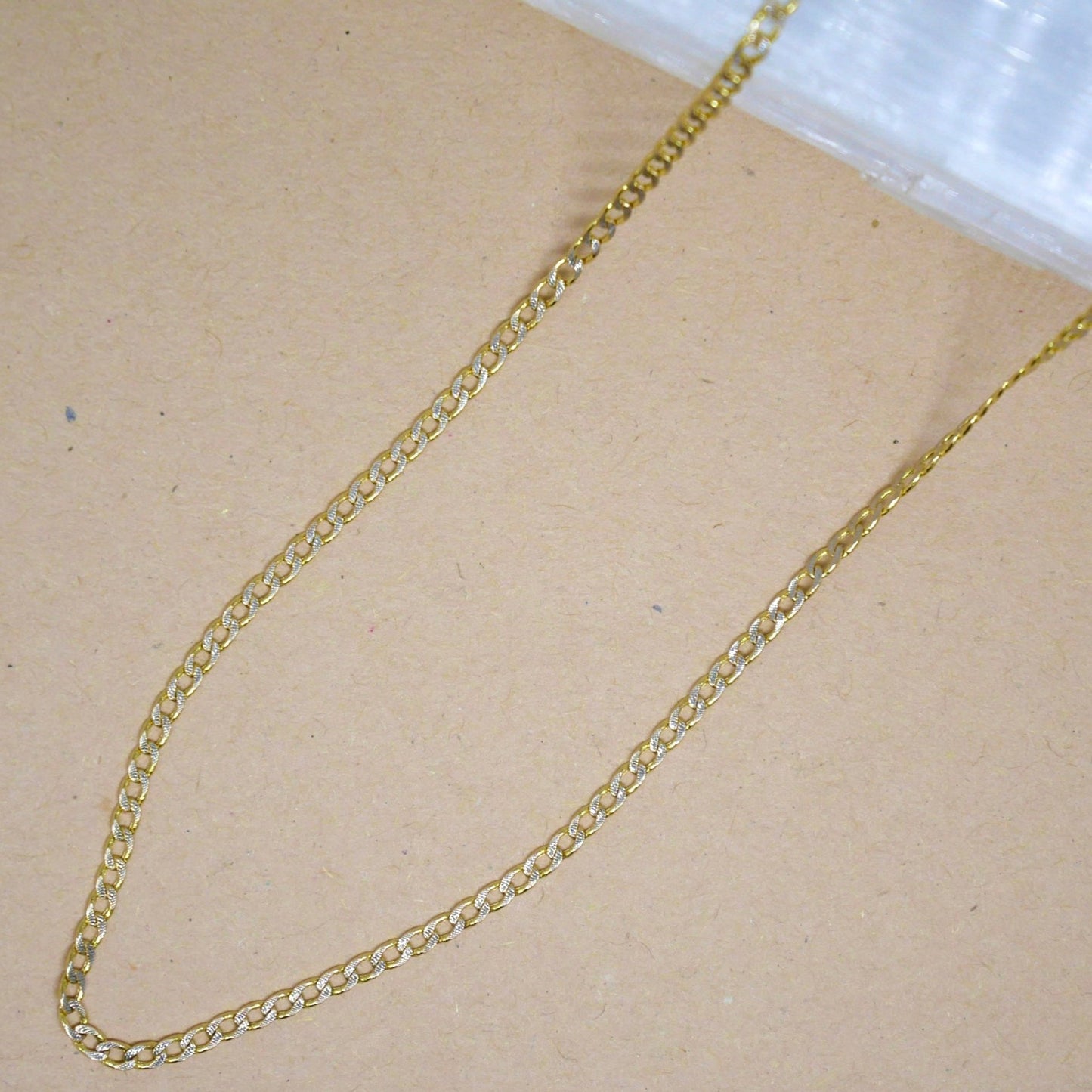 14k solid gold chain with a polished finish, featuring a secure lobster clasp, designed for versatile wear—perfect for layering or wearing solo.