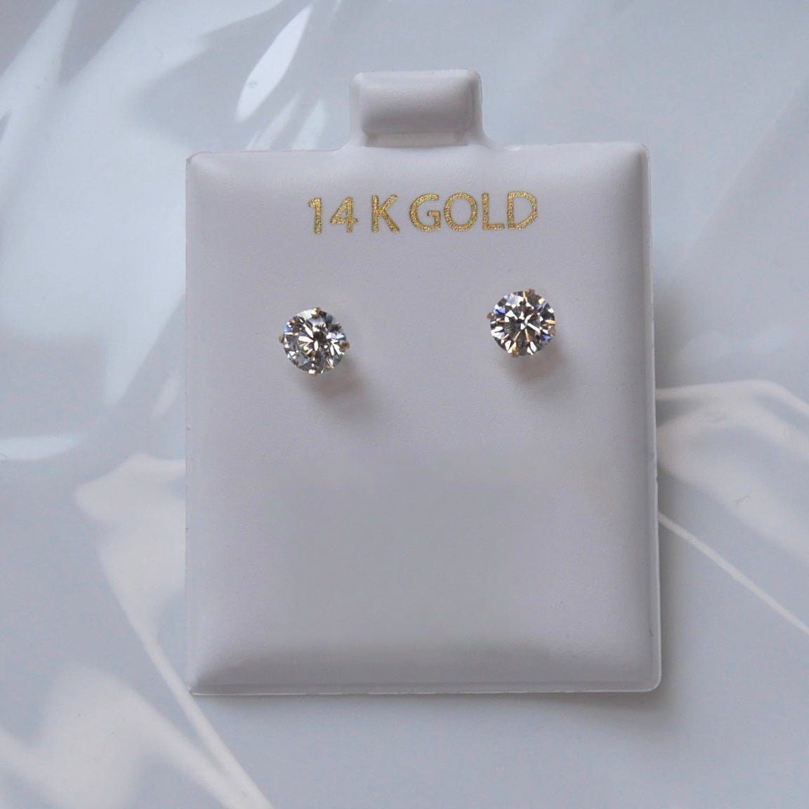 14k solid gold  stud earrings featuring high-quality cubic zirconia stones in a classic 4-prong setting, ideal for everyday elegance.