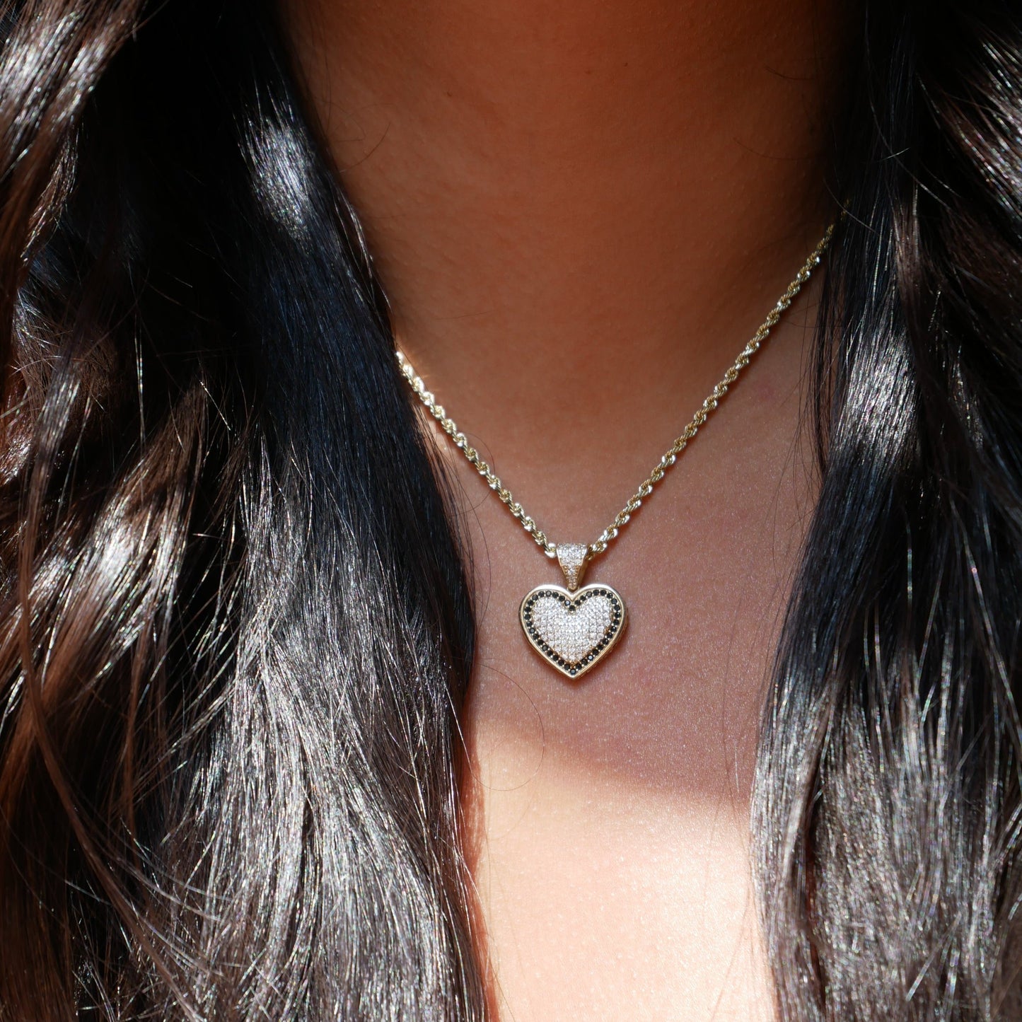 14k solid gold heart-shaped pendant featuring sparkling pave-set stones and black accents, offering a timeless and elegant design perfect for daily wear or special occasions.