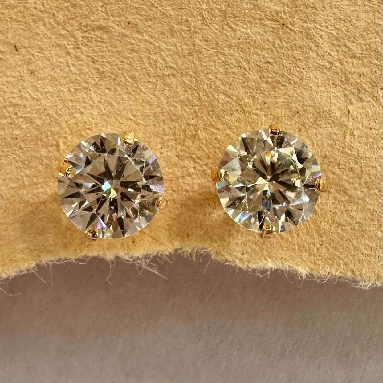 14k solid gold  stud earrings featuring high-quality cubic zirconia stones in a classic 4-prong setting, ideal for everyday elegance.